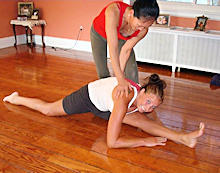Son Hui helps a student reach a proper alignment